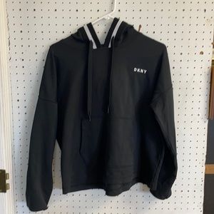 DKNY black crop top w/white stripe on hood. Size L